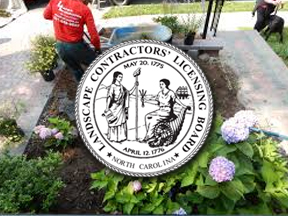 Landscaper working in garden with licensing board seal