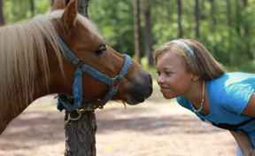 Girl kissing horse