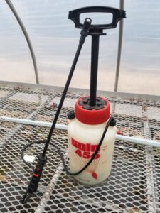 White spray jug on wire table.