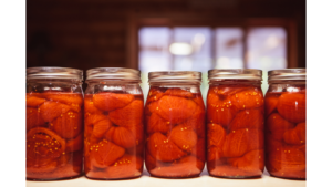 row of jars with canned tomatoes inside